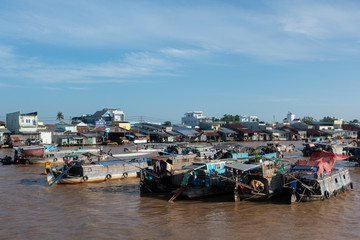 Fototapeta na wymiar Tourists, people buy and sell food, vegetable, fruits on vessel, boat, ship in Cai Rang floating market, Mekong River. Royalty stock image of traffic on the floating market or river market in Vienam