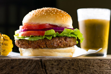 Hamburger meat tomato onion lettuce corn on the cob beer