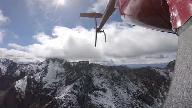 New Zealand helicopter flies over snowy mountains, POV