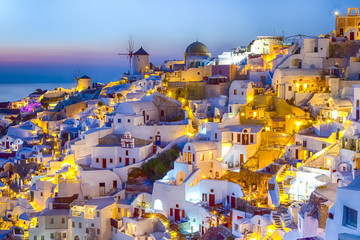 Travel Concepts. Skyline of Oia Town with Traditional White Architecture and Iconic Windmills in Village of Santorini in Greece.World Famous Resort.