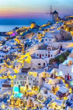 Fototapeta Travel Concepts. Skyline of Oia Town with Traditional White Architecture and Iconic Windmills in Village of Santorini in Greece.World Famous Resort.