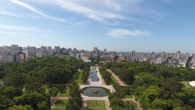 Park in center of city. Green area surrounded by a city. Blue sky with clouds. Aerial scene. Porto Alegre, Brazil. 2nd segment.