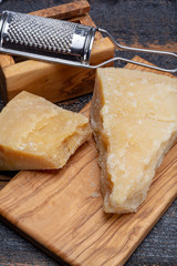 Traditional italian food - 36 months aged in caves Italian parmesan hard cheese from Parmigiano-Reggiano, Italy