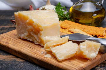 Traditional italian food - 36 months aged in caves Italian parmesan hard cheese from Parmigiano-Reggiano, Italy