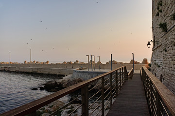 Obraz premium Pier in old small city Giovinazzo near Bari, Apulia, Italy in early morning