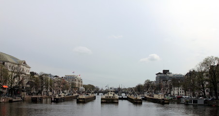 Fototapeta na wymiar Amsterdam in April, 2016. Netherlands. Amsterdam cityscape with houseboats.