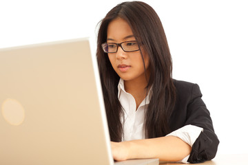 Attractive young Asian businesswoman typing on laptop computer