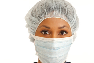 Close up of female surgeon wearing mask and hair net on white backdrop