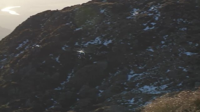 Helicopter out of sun along tussock