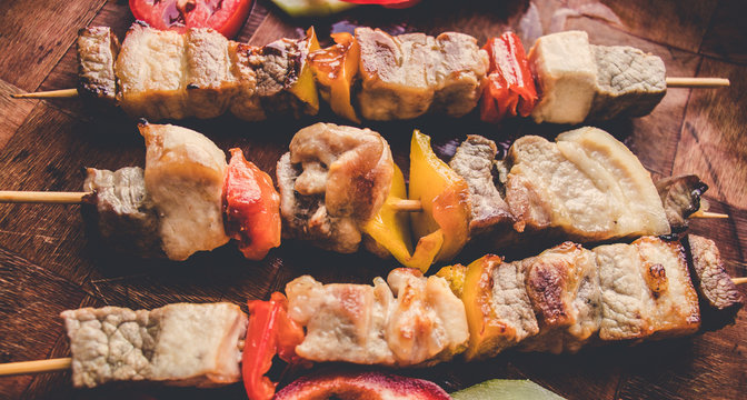 Grilled meat with vegetables. Barbecued shish kebab or shashlik on sticks