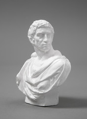 a plaster figure with a gray background