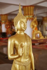gold buddha statue in public temple Thailand