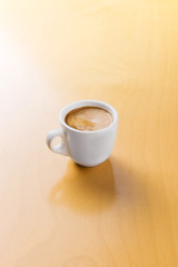 Hot espresso on the wooden table