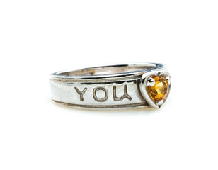 classic ring with a yellow topaz stone on white background