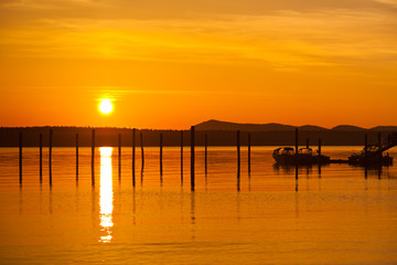 Fototapeta na wymiar Golden orange sunset in Anacortes, WA Ship harbor