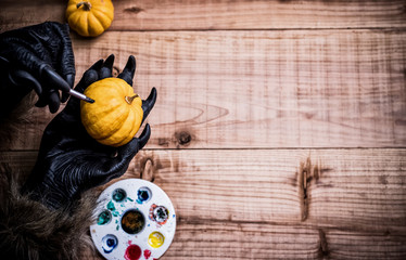 Happy Halloween. Werewolf or zombie hands painting scary pumpkin for trick or treat party. copy...