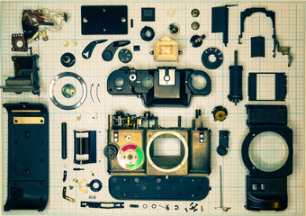 Fototapeta premium parts old retro film SLR camera on graph paper