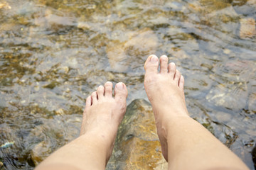 Female feet overlooking on the river.