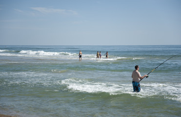 A man fishing on the beach
