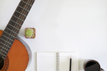song writer table a workspace with musician acoustic guitar and coffee cup with notepad paper on...