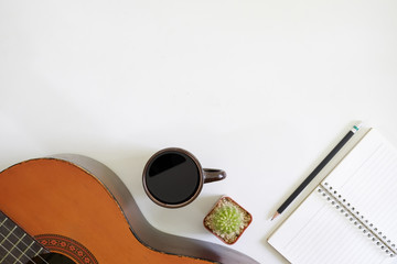 song writer table a workspace with musician acoustic guitar and coffee cup with notepad paper on...
