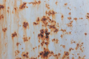Rusty metal background with streaks of rust.