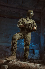 Fototapeta premium the people in uniform with weapons in the ruins