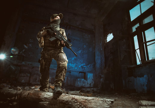 the people in uniform with weapons in the ruins