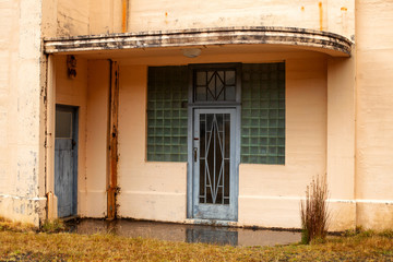Fototapeta na wymiar Entrance door in an old abandoned art deco building