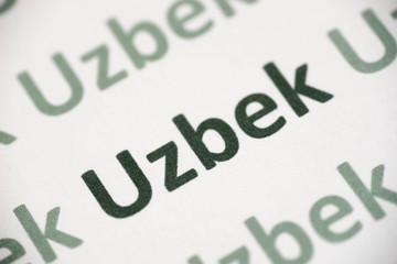 word Uzbek  language printed on paper macro