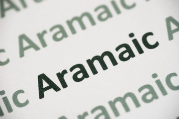 Fototapeta premium word Aramaic language printed on paper macro