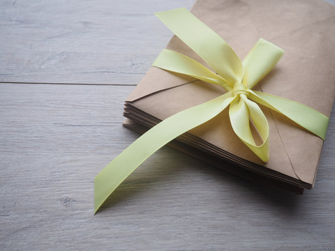 Gift Kraft Envelope With A Ribbon On A Wood Background