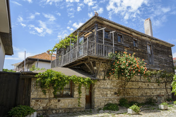 traditional house in the city of nessebar, Bulgaria. flower, vibrant blue summer sky.