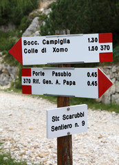 Road sign of the mountain path  in Italian language to go to Pas