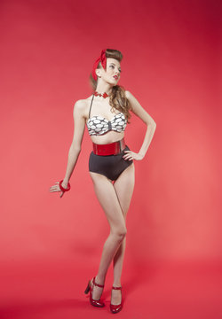 portrait of girl in pin up style on red background
