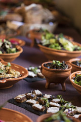 Medieval dishes on a plate on a purple tablecloth