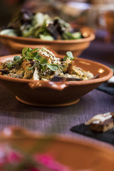Medieval dishes on a plate on a purple tablecloth
