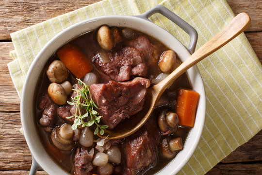 Traditional French Food: Coq Au Vin Cock With Wine And Vegetables, Thyme Close-up In A Pot. Horizontal Top View From Above