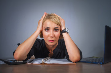 young beautiful stressed and sad blonde woman working with laptop computer feeling tired sitting at...