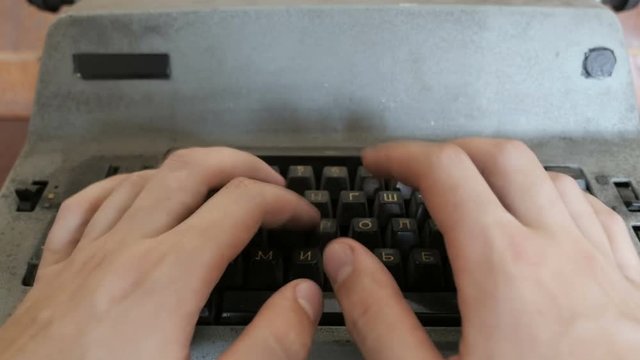 Creative Writing, old typewriter. Closeup of male hands typing on old typewriter
