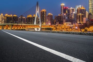 Fototapeta premium Road pavement and Chongqing urban architecture skyline