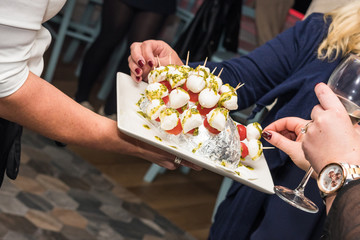Finger food ready on a dish for party or events on a plate served by the waiter.