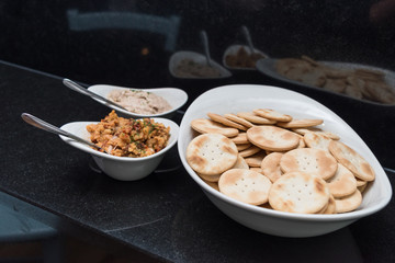 Finger food ready on a dish for party or events in white bows ready with spoons