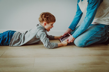 Naklejka premium computer addiction- father taking touch pad from angry child