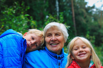 happy grandmother and grandkids enjoy being together in nature