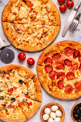 Set of different pizzas - pepperoni, vegetarian, chicken with vegetables
