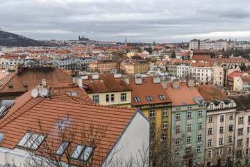 Obraz premium Storm clouds over red tile roofs