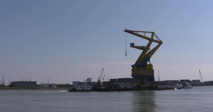 transport of a floating grab crane, mounted on a pontoon, in Rotterdam seaport.