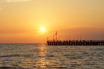 Fototapeta na wymiar jetty in the sunset in versilia