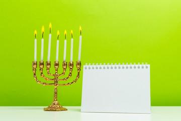 Bronze Hanukkah menorah with burning candles